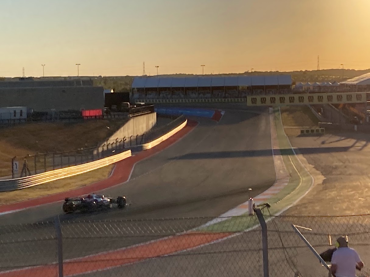 Formula 1 car on track at sunset
